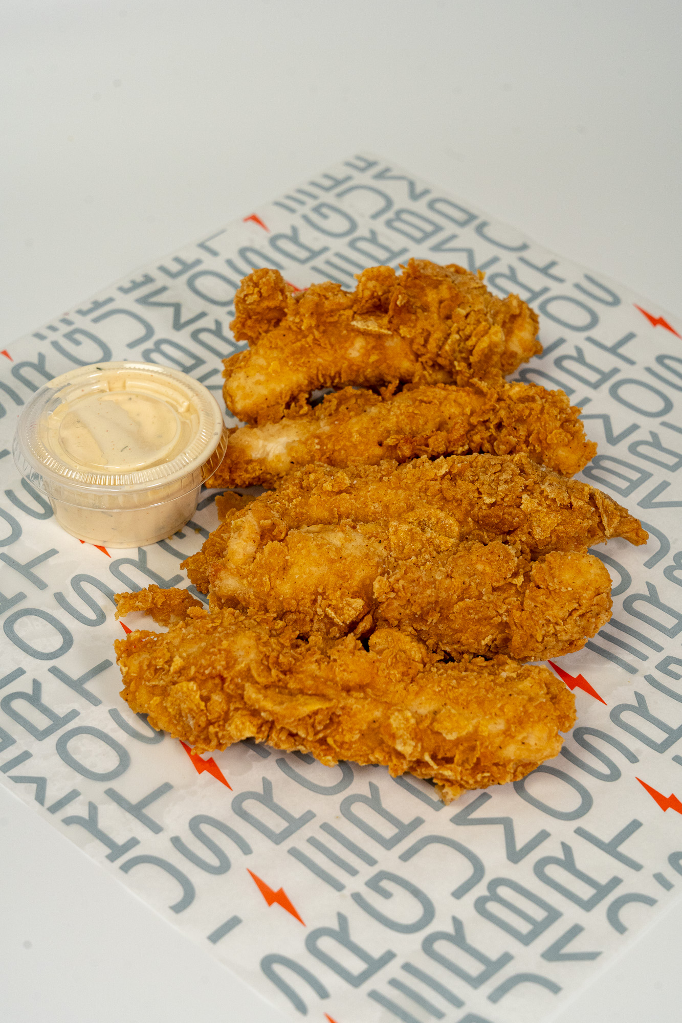 Hand-breaded chicken strips with house sauce at StormBurger in Inglewood and Long Beach