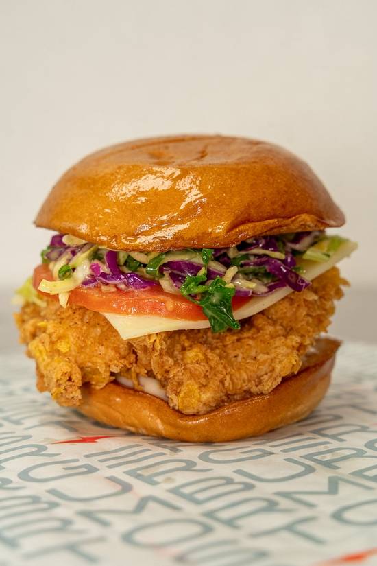 Deluxe Chicken Sandwich at StormBurger — Fresh buns, mayo, all-natural and hand-breaded chicken, tomatoes, swiss cheese, homemade kale slaw